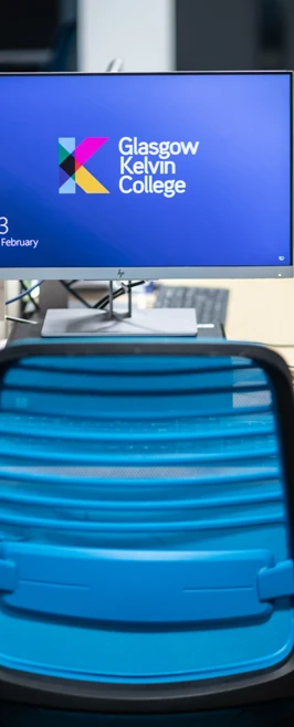 Close-up of a Glasgow Kelvin College computer desk with a blue chair and monitor displaying the college login screen.  Close-up of a Glasgow Kelvin College computer desk with a blue chair and monitor displaying the college login screen.